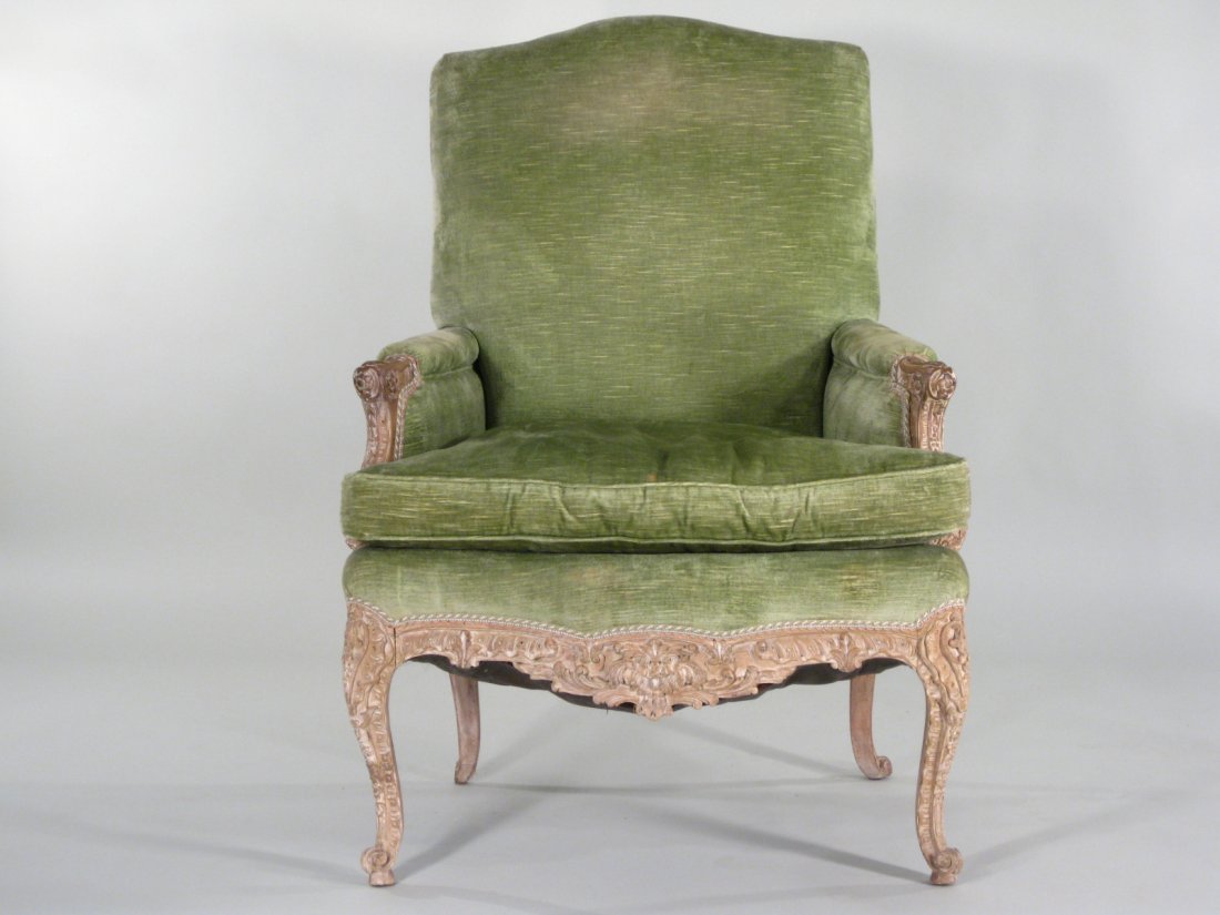 Louis XV Style Green Velvet Bergere, 20th C.: Louis XV Style Green Velvet Upholstered Bergere, 20th C., the bergere with much carving of floral, shell and bell form decoration to arms and legs with a whitewash distressed effect. (MRAP959) {LJS} D
