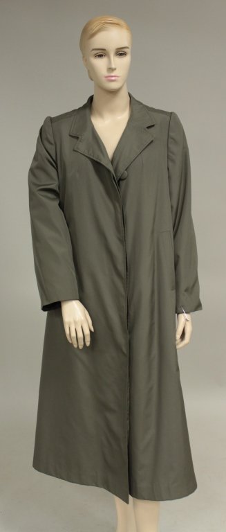 Green Fur Lined Raincoat: Green nylon blend, 3/4 length, button front raincoat with sheared fur lining and front slip pockets. Size large. (GPRI7805) {KR}(GPRI) Dimensions: Condition:Use wear. From the Estate of Barbara Gould 
