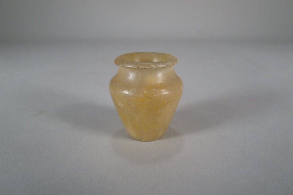 Ancient Egypt Alabaster Unguent Pot, c. 1900 BC: An ancient Egypt Alabaster Unguent Pot, Middle Kingdom, Dynasty 12, c. 1900 BC., possibly a tomb model.(FARO8201) Measurements: 1.5 H Condition: Condition commensurate with age and use. Small chip to