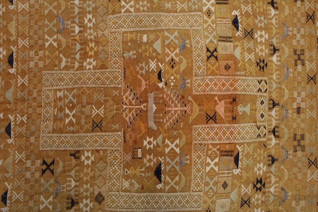 Woven Rug, "Coptic Cross": Woven Rug, orange ground "Coptic Cross" with animals, birds, and figures(RANDJ8702) Measurements: 6' 2" x 9' Condition: Holes at one end, crease folds, fading and soiled. Property Title: Purchased fro