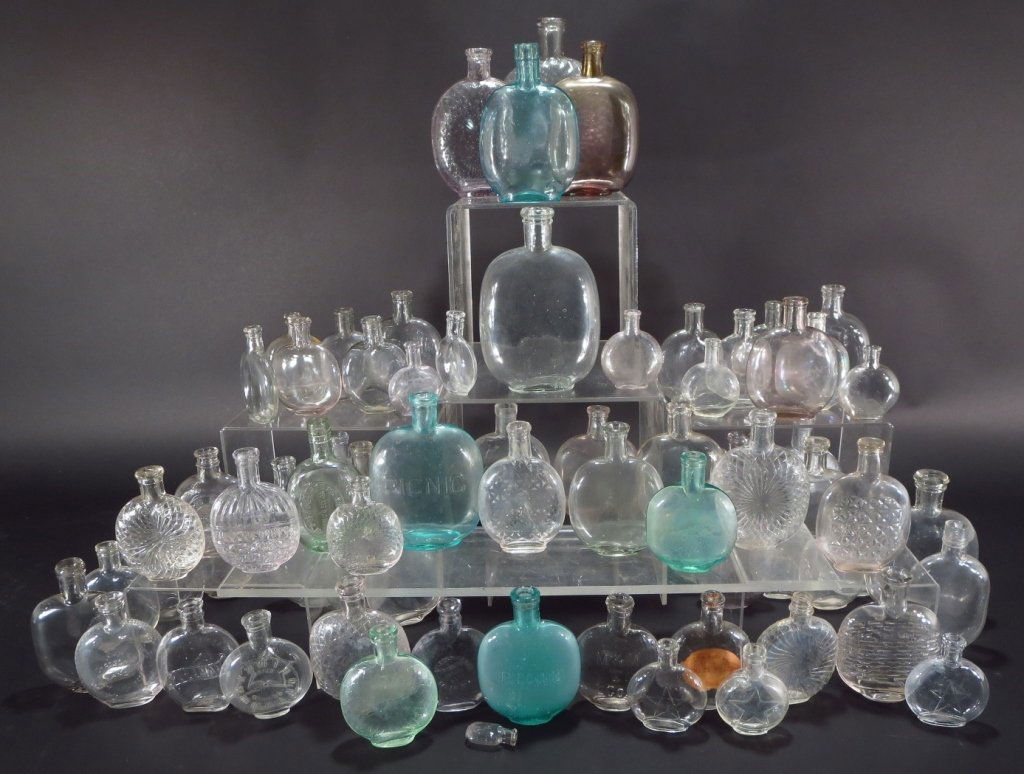 Group of Pumpkin Seed Flasks, American: Group of Pumpkin seed flasks, American, 19th C. Whiskey flasks in various sizes, some with embossed designs. Approximately 68 pcs.(VHOLT8301/LOT) Measurements: Tallest 7 7/8" H. Condition: Some have r