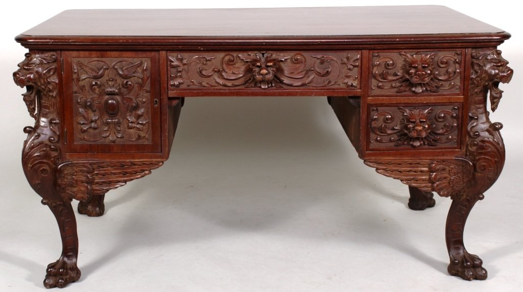 Victorian Partners Desk, American, c. 1900: Victorian oak Partner's Desk, American, c. 1900, with drawers and cabinet fronts ornately carved with lion's heads, on paw feet. (LCA8210)(LCA8210) Measurements: 30 H x 56 W x 34 D Condition: Age and 