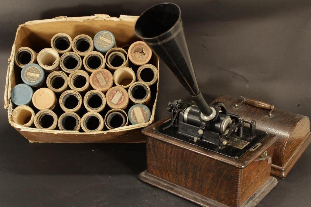 Edison Standard Phonograph with Box of Cylinders: Edison Standard Phonograph with Cylinders and Horn, oak case, c. 1912, serial 438152. Approximately 30+ cylinders in cardboard sleeves.(KCRA8004/3) Measurements: standard Condition: lacking winding ha
