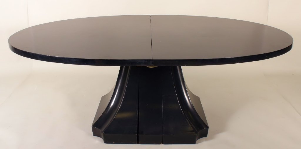 Black Lacquer Oval Modernist Dining Table: Black Lacquer Modernist Single Pedestal Oval Dining Table, mid 20th C., with two leaves. Biography The Burke residence on Long Island, "Holly Pond", is a modernist architectural masterpiece designed a