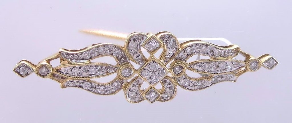 14K Gold and Diamond Brooch Edwardian Style: 14K Gold and Diamond Brooch Edwardian Style set with 32 diamonds totaling approx .40ct.(CDB10341)(PR) Measurements: 15/8"L Condition: Good