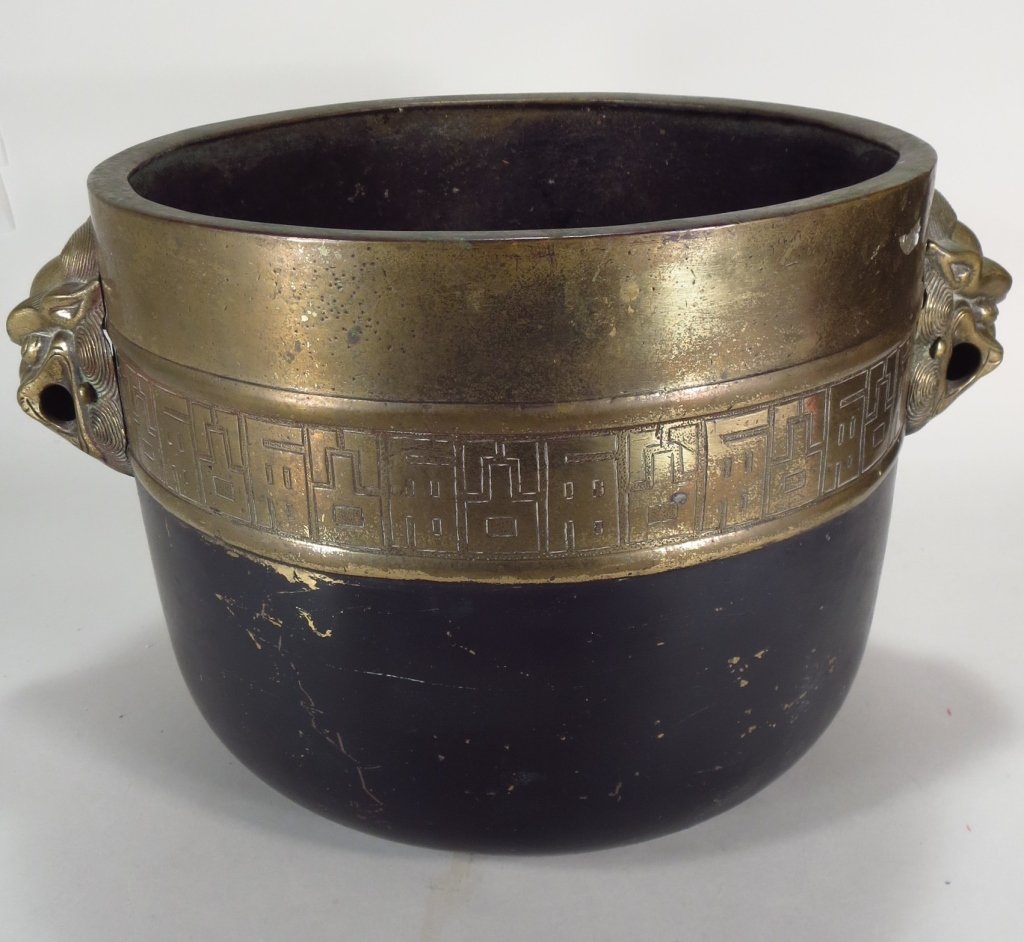 Asian Brass Jardiniere with Lion's Head Handles: Asian Brass Jardiniere, with Lion's Head handles.(SNOR2200) {WK} Measurements: 10 H x 12.5 Dia. Condition: Age and use wear, dings abrasions, dents.