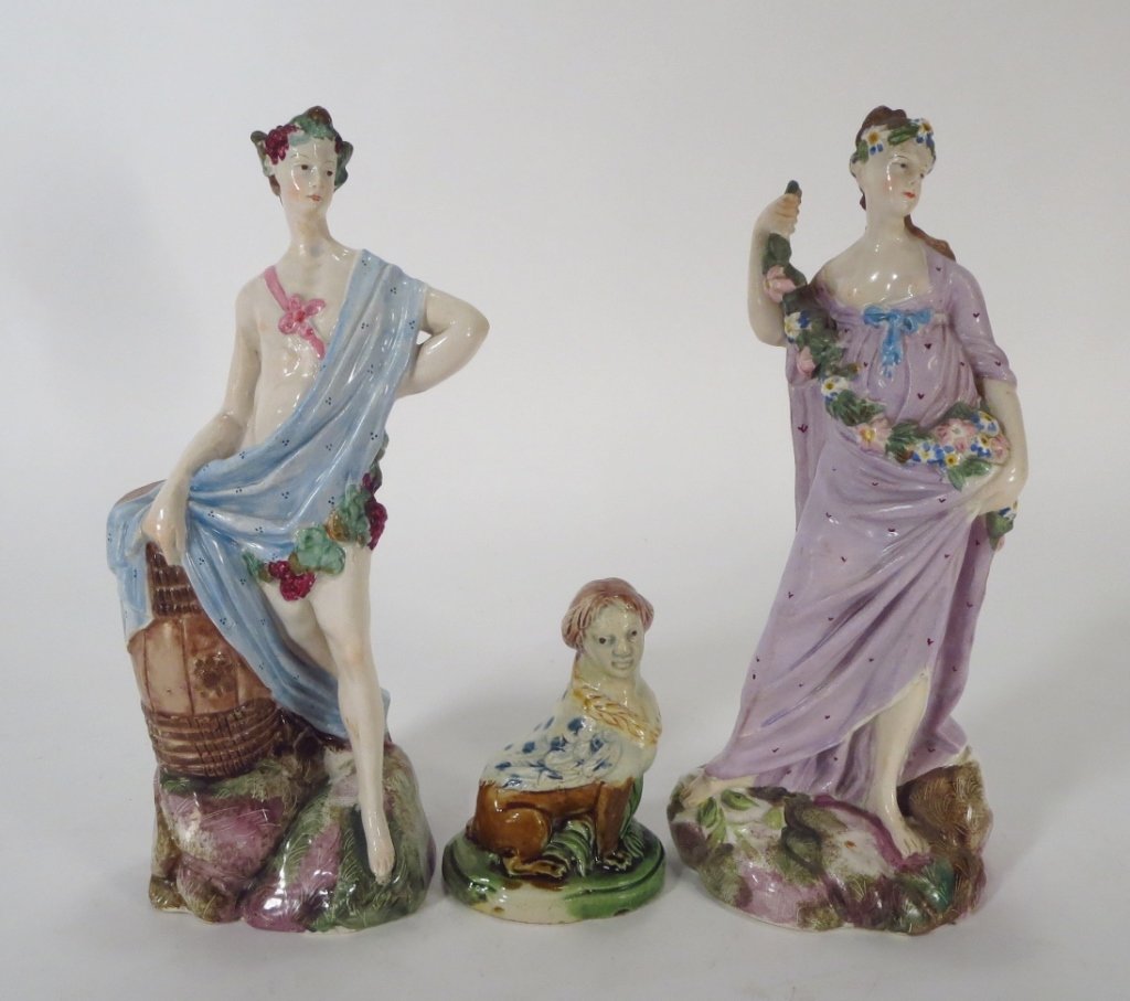Three Staffordshire Style Figures: Three Staffordshire style porcelain figures, including a couple in classical dress, and seated Sphinx.(RIVERS4265/3)(WK) Property Title:From the Estate of Joan Rivers. Measurements: Couple: 9 H