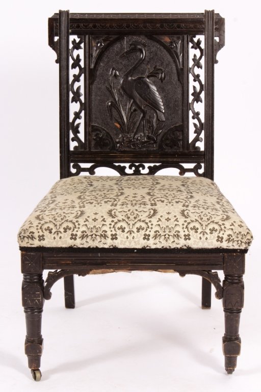 Aestheticism Hall Chair Bas-Relief Am Late 19th C: Aestheticism Hall Chair Bas-Relief of a Crane and reticulated Vine Motif, American, Late 19th C., ebonized mahogany, castors on front legs.(SLMA7401)(AC) Measurements:Chair: 32 1/2" x 22" x 18 1/2" Se