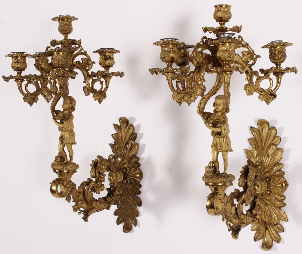 Pair of French Ormolu Sconces, Late 19th C.: Pair of Ormolu Sconces, French, late 19th C., each 3 candled arms upheld by children, amidst scrolling grape vines.(VAL5200/2)(WK) Measurements:21" H x 1" W x 13" D Property Title: