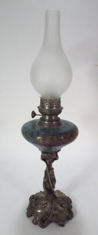 French Art Nouveau Pottery and Cast Metal Lamp: A French Art Nouveau Pottery and Cast Metal Lamp, c. 1890, the base finely cast with leaves, tendrils, and poppy pods; the art pottery with mottled green base with lavender and olive highlights(DJOD70