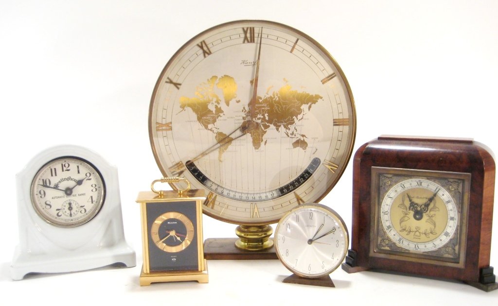 Group of 5 Mantel/Desk Clocks,20th C.: Group of 5 Metal and Wood Mantle/Desk Clocks, 20th C., includes Black Starr & Frost, Elliot London, Retro Kienzle World time clock, Lexington and Bulova(DMAS7807/5)(MM) Measurements:Varies from Lexing