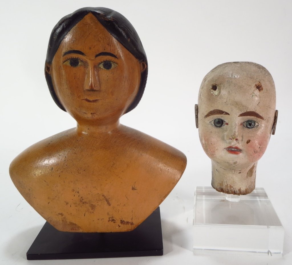 Two Antique Dolls' Heads, 19th C. and earlier.: A wood shoulder Doll's head, probably Swiss, late 19th C., together with an antique wood doll's head with leather ears, possibly 18th C.(DJOD7227/2)(WK) Measurements:5.5 and 8 H Property Title: