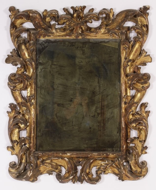Italian Baroque Carved Giltwood Frame/Mirror, 18th: A large Italian Hand Carved Giltwood Frame Mirror, early 18th, possibly 17th c. , currently as mirror with a later beveled plate.(RJUL7010)(TC) Measurements:45" H x 36" W, mirror plate 29" H x 22" W P