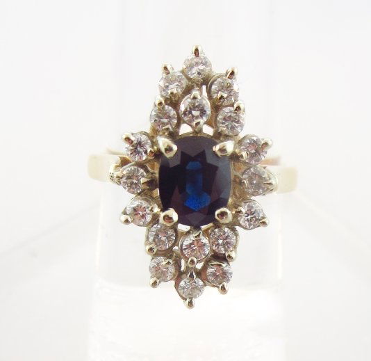 14K Yellow Gold Sapphire & Diamond Ring: 14K Yellow Gold Sapphire & Diamond Ring, center oval sapphire surrounded by 18 diamonds, totalling approx. .5 ct [2] (JTEX8309) {PR} Measurements: Size 6.5