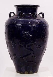 Chinese Qing Dynasty Martaban Storage Jar: A Chinese ceramic Martaban jar, Late Qing Dynasty, ovoid body rising to a narrow neck and a flared rim, the body decorated with two raised horizontal bands, , the sides of the jar decorated with drago