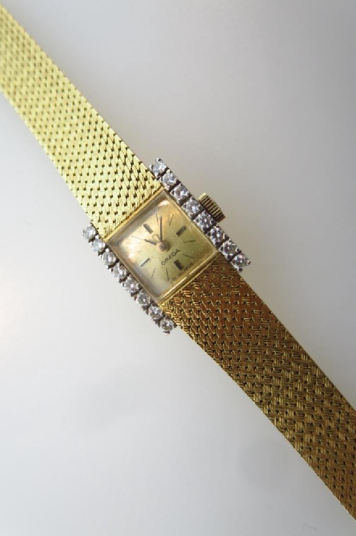 Omega Ladies Wristwatch 18 kt Gold w/ Diamonds: Omega Ladies Wristwatch 18 kt Gold w/ 16 Diamonds, approx .3 each, marked: Swiss made 750 65", inclusive total wt. 20.1 dwt. tightly woven tapered mesh band. (PJEW1405) {AC} Property Title: Measuremen