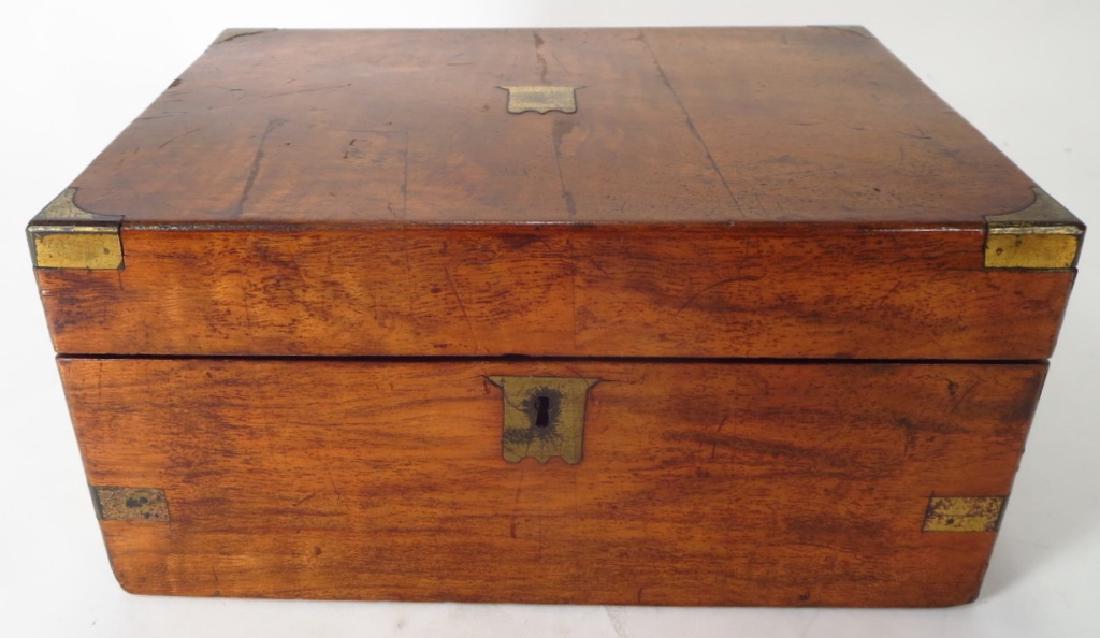 Mahogany Campaign Desk, 19th C.: Mahogany Campaign Desk, 19th C., inset brass binding at corners and sides, both top and keyhole with brass fitted shield shaped escutcheon, fitted with interior compartments[081] (LKIR1100) {MM} Prope