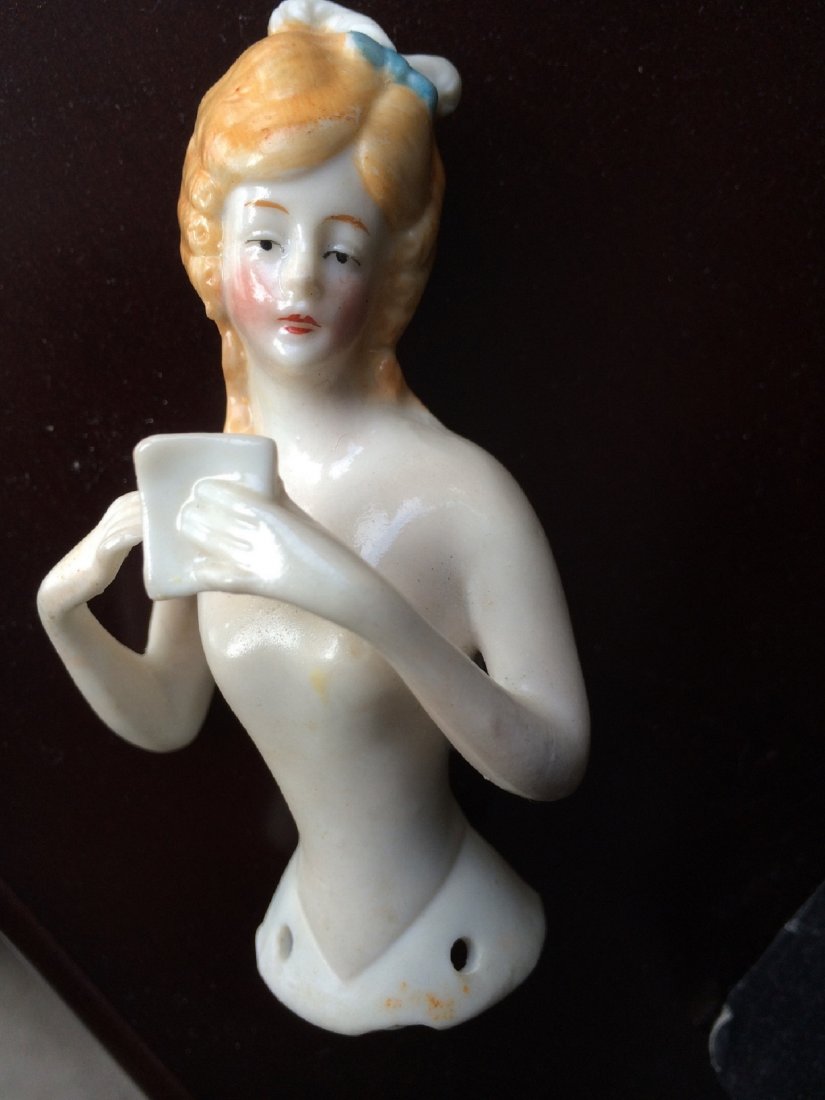Ceramic Half Doll: German ceramic half doll or pincushion doll.Both arms extended from body. Stamped Germany 14234.Good colour and condition. Chip at base-may be mould flaw.