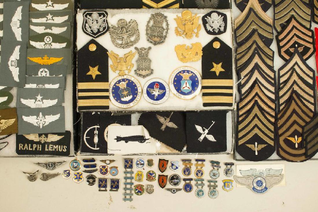US Navy, USMC, USAF, CAP, and Army Aviation Badges and: Frame 1: 9 US officers' and enlisted peaked cap badges, 5 metal and 2 embroidered, 3 large enameled breast badges, and a pair of US Navy Lieutenant Commander's shoulder boards, all excellent. Frame 2:
