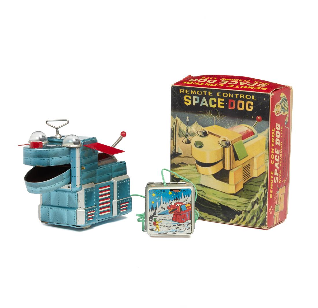 Remote Control Space Dog Tin Litho Toy, Original Box: Remote control Space Dog tin litho toy with flashing lite in original box. Separate tin case for batteries. Made in Japan. Dimensions: 4.5"h x 7.25"l. Processing and shipping within the continental U.