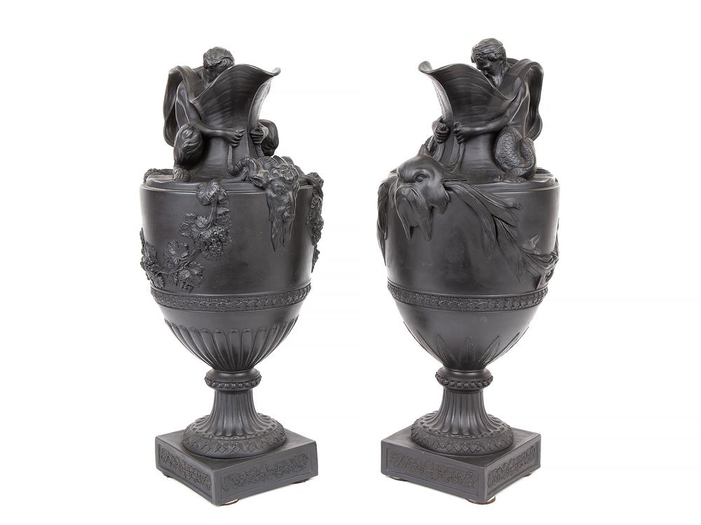 Two Wedgwood Basalt Wine and Water Ewers: Pair of Wedgwood Black Basalt Wine and Water Ewers, England, 19th century, the water ewer with a figure of Triton seated atop the shoulder and modeled holding the horns of a marine monster below the s