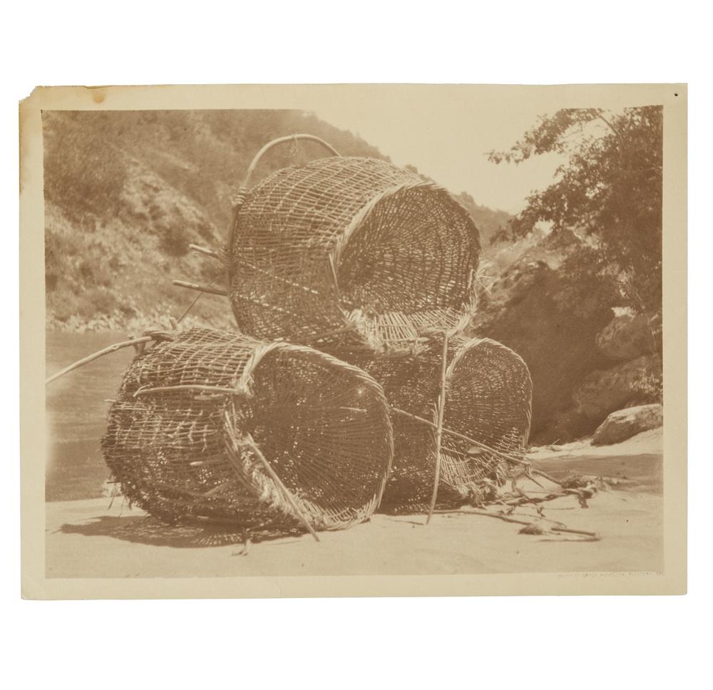 Grace Nicholson Photograph Of Yurok Eel Traps: Photograph of Yurok eel traps on Klamath River by Grace Nicholson. Handwritten in ink description verso. Stamped, verso, "Photo by Grace Nicholson, Pasadena, Cal." Also noted right lower corner. Dimen