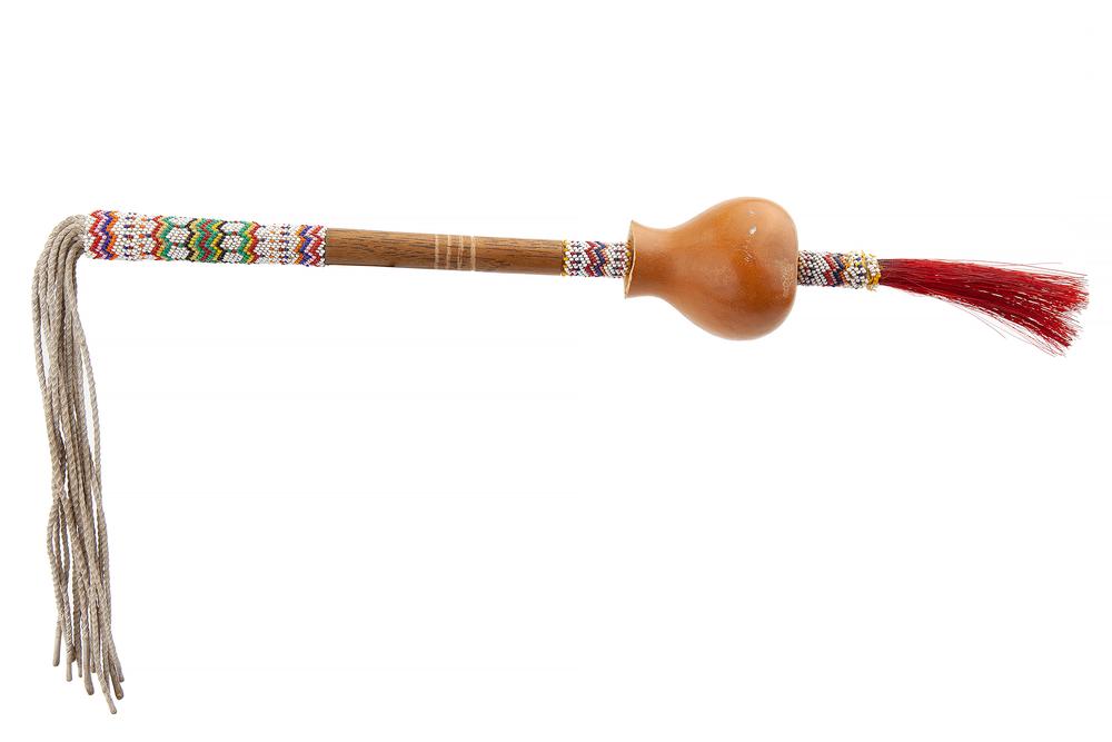 Peyote Rattle & Feather Dance Wand: Lot of two Native American items comprising a Kiowa beaded peyote rattle (22"l) and a beaded feather dance wand (21"l). Provenance: Estate of Richard Radcliffe, Murray, Utah. Processing and shipping w