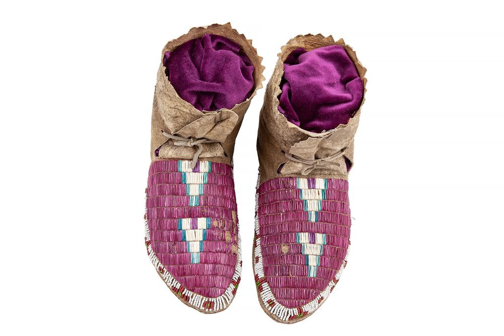 Quilled Plains Moccasins: Quilled Plains woman's moccasins with beading on sides. Sinew sewn. Circa 1800s. Dimensions: 9.5"l. Provenance: Estate of Richard Radcliffe, Murray, Utah. Processing and shipping within the continenta