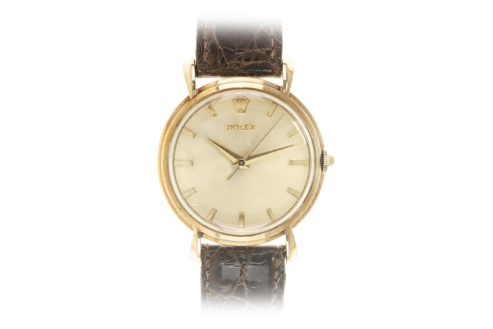 14k Rolex Manual Wind Watch: 14k Rolex manual wind watch. Ref #4570. Serial #500882. Circa 1940s. Rolex strap with 18k Rolex buckle. 34mm. Processing and shipping within the continental U.S. $30.00 plus 1.5% replacement cost insu