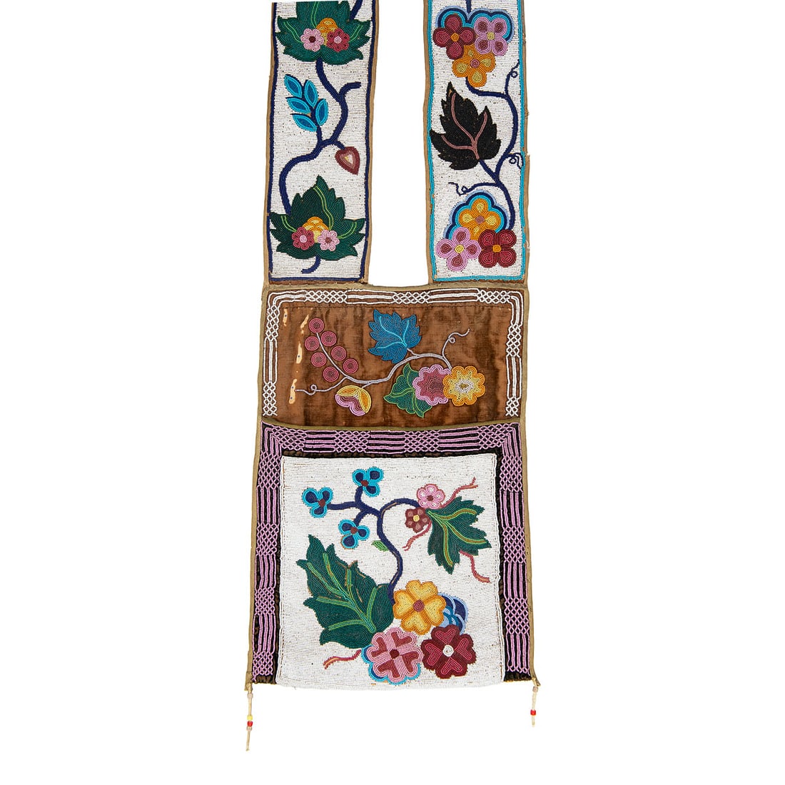 Late 19th Century Ojibwa Beaded Bandolier Bag: This classic Ojibwa bandolier bag is fully decorated in colorful contour beadwork with curvilinear floral motifs on a cotton trade cloth ground. The shoulder straps are bordered in white with compleme