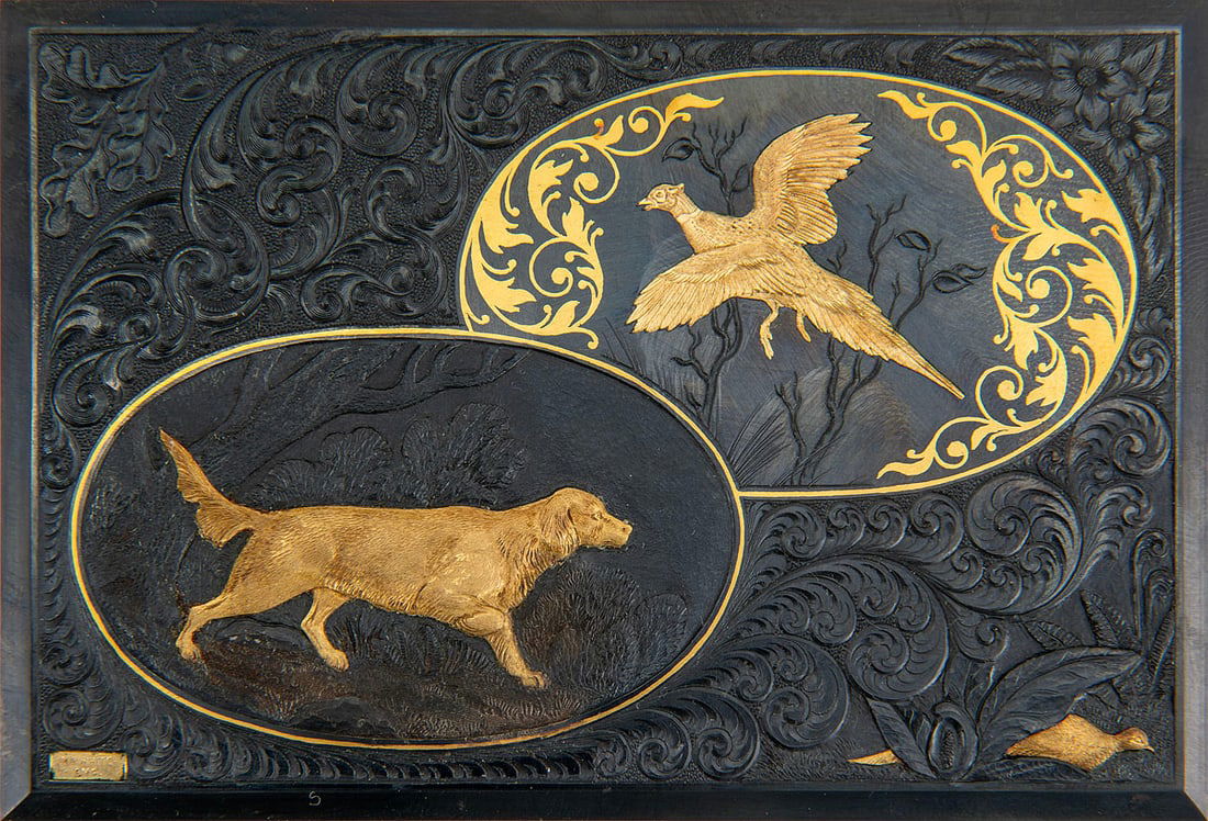 Boxed Gold Inlay and Engraving Steel Panel by A.A. White, Manchester, CT: An engraved steel sample panel by A.A. White Engravers, Inc., Manchester, Connecticut, showcasing the studio's signature gold inlay techniques. The detailed relief work features a pair of hunting dogs