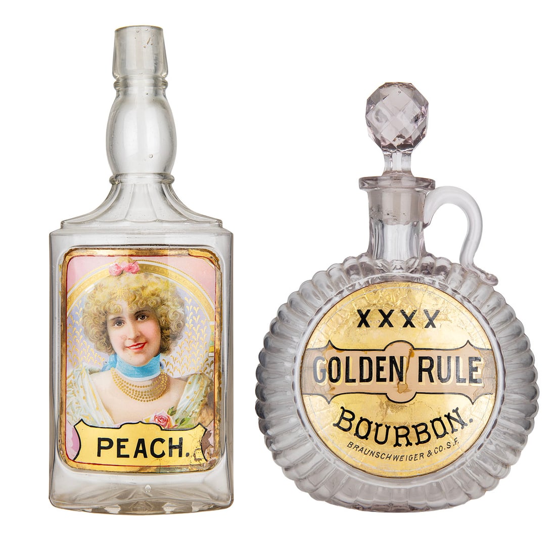 Two Label-Under-Glass Back Bar Whiskey Bottles: A pair of early 20th-century whiskey back bar bottles, each featuring colorful label-under-glass advertising panels. The first is a round decanter-style bottle labeled "XXXX Golden Rule Bourbon / Brau