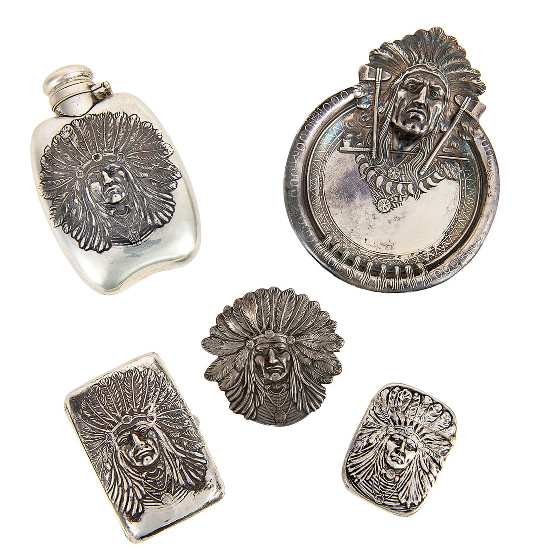Collection of Five (5) Unger Brothers "Indian Chief" Sterling Silver Items, ca. 1900: Group of five sterling silver items by Unger Brothers, each depicting a bold repousse portrait of a Native American chief in feathered headdress. Includes a curved flask (2 3/4 x 4 1/4 in.) with scrol