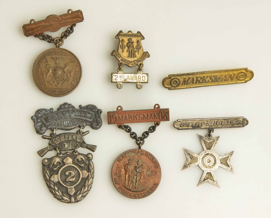 U.S. Medals and Badges: National Guard of Pennsylvania 1908 Marksmanship Medal in bronze; U.S. Treasury Defense Agent Award of Merit pin with 2nd Award bar; silver “Sharpshooter” cross; gold colored “Marksman” bar. 1