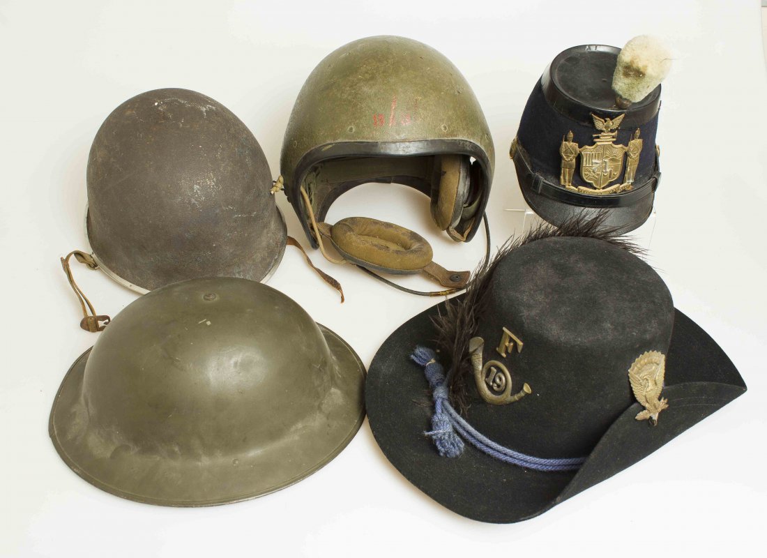 Group of U.S. Helmets, Shakos and Military Hats: 1. U.S. Army Vietnam era pilot’s helmet with lining and ear pieces. 2. U.S. WWII G.I. steel helmet and liner. 3. U.S. Shako with Medical side buttons and beautiful high quality helmet plate of the 7