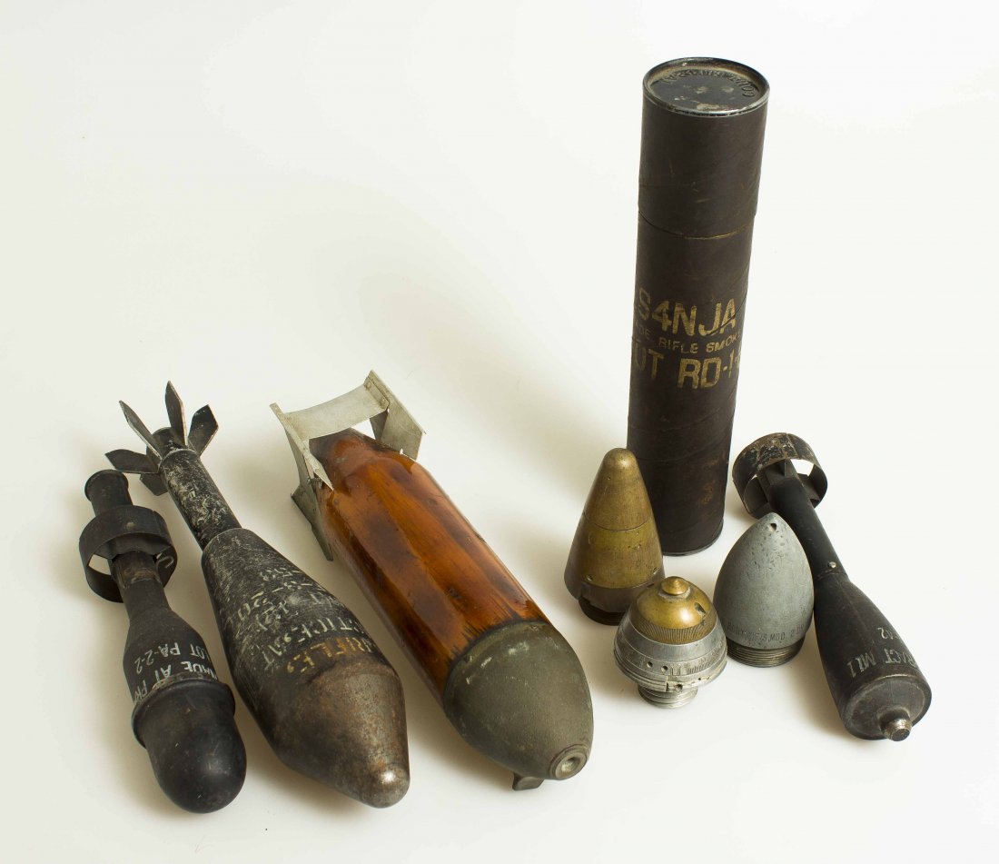 Four Practice Ordnance Rounds: 1. An early pre-WWII practice aerial bomb, wood, with aluminum fins. 2. U.S. M11 A-3 Practice Smoke Grendade for Rifle 3. American large practice rifle grenade, 14 inches long. 4. American practice ri