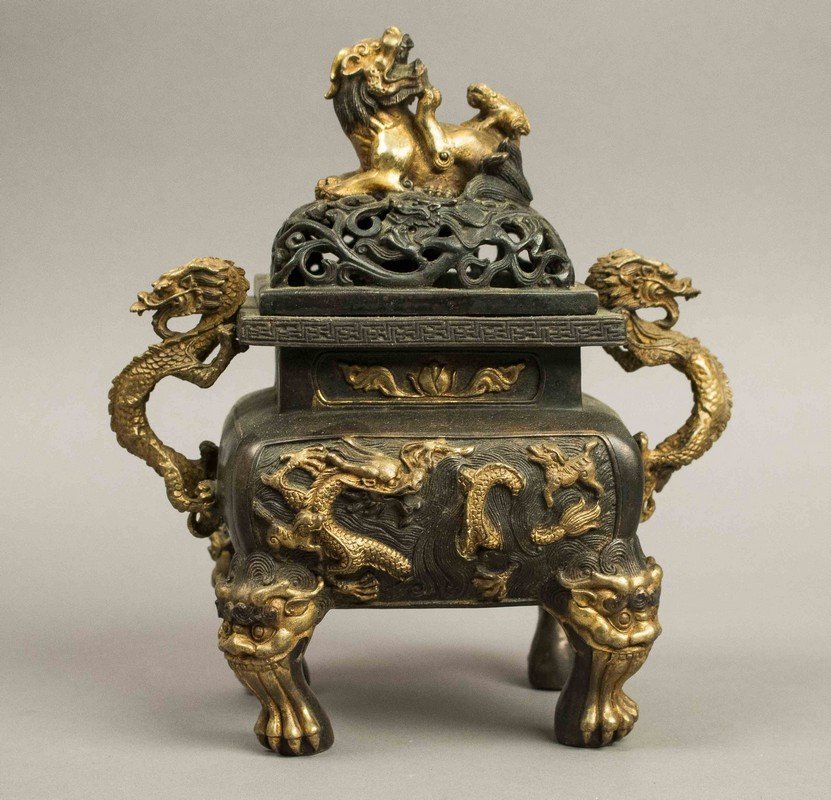 Chinese Bronze Incense Burner: Chinese Bronze Incense Burner with gold guardian lion lid, dragon handles and body decorated with dragon motifs. Marked on base. Processing and shipping within the continental U.S. $32.00 plus 1.