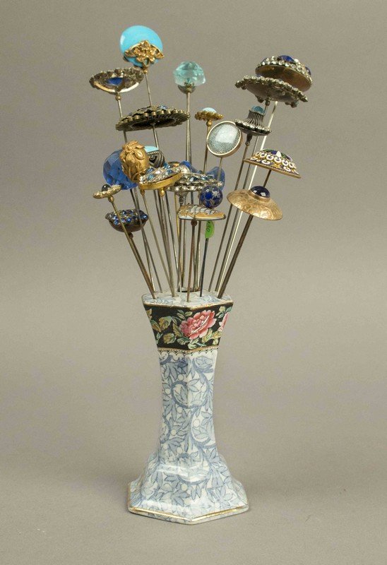 Victorian Hatpins with Mostly Blue Stones: Victorian Hatpins with Mostly Blue Stones. Approximately 24 hatpins with colored stones, rhinestones and gold filigree in a porcelain holder. Processing and shipping within the continental U.S. $25.0