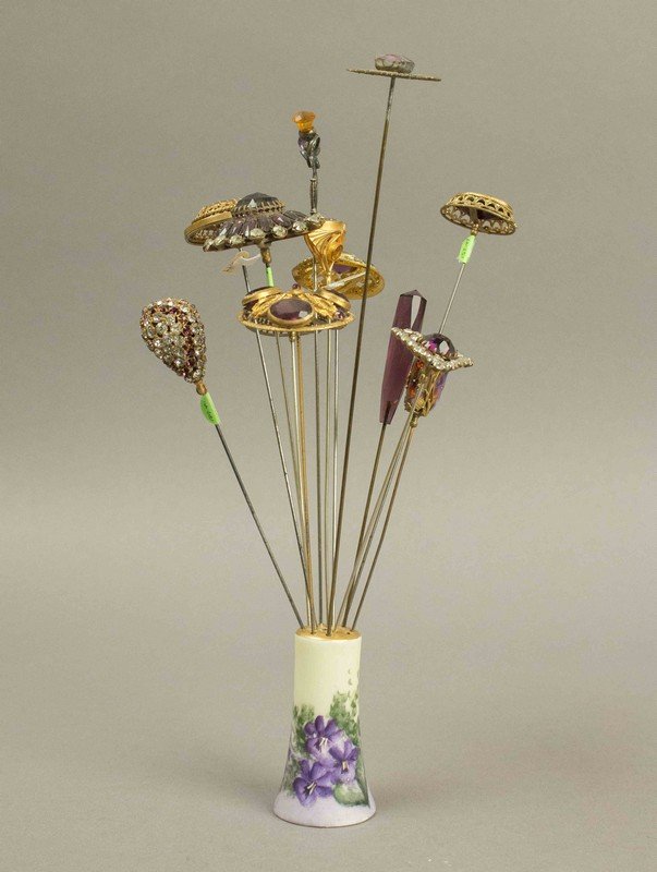 Victorian Hatpins with Purple & Pink Stones: Victorian Hatpins with Purple & Pink Stones. Approximately 14 hatpins with colored stones, rhinestones and gold filigree in a porcelain holder. Processing and shipping within the continental U.S. $25