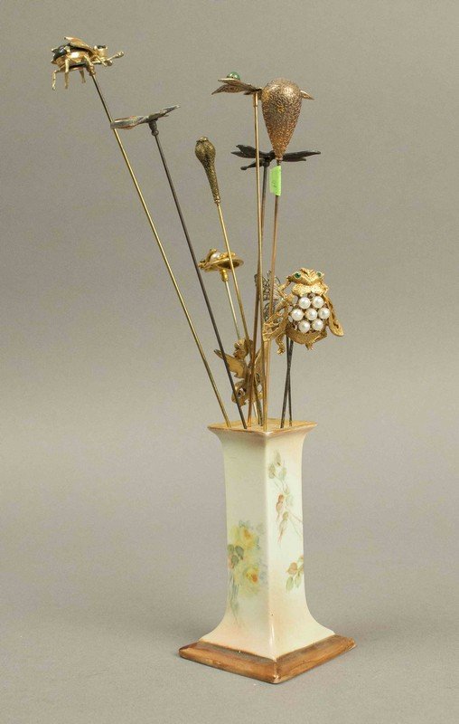 Victorian Hatpins with Butterflies, Insects & a Dragon: Victorian Hatpins with Butterflies, Insects & a Dragon. Approximately 10 hatpins with colored stones, pearls and gold filigree in a porcelain holder. Processing and shipping within the continental U.