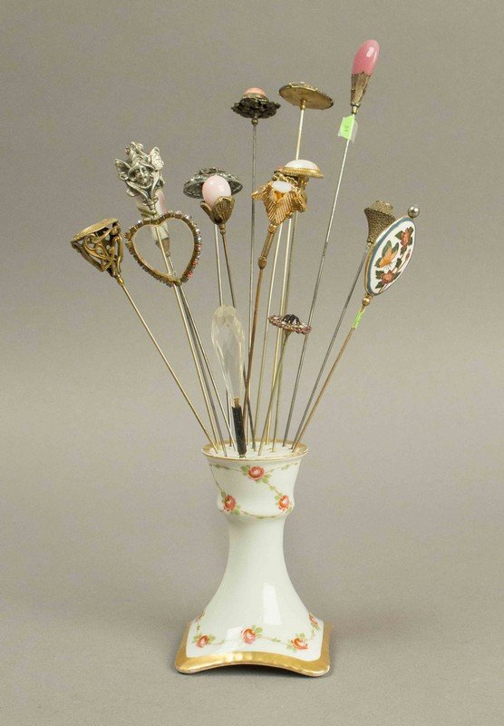 Victorian Hatpins with Art Nouveau Settings: Victorian Hatpins with Art Nouveau Settings. Approximately 11 hatpins with colored stones, gold filigree and cast metal pieces in a porcelain holder. Processing and shipping within the continental U