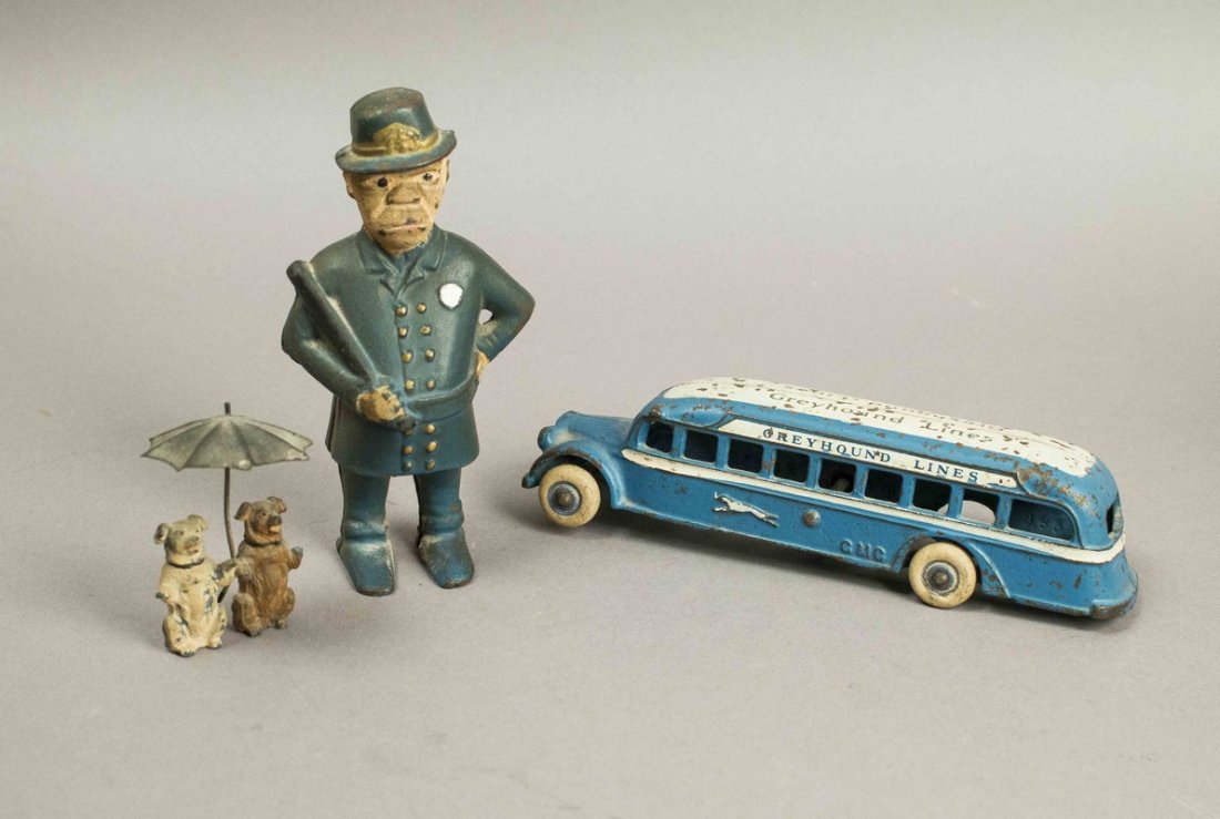Arcade Greyhound Bus, Cast Iron Still Bank & Lead Dogs: Arcade Greyhound Bus, Cast Iron Still Bank & Lead Dogs. The bus has "GMC" cast in its sides. The tin umbrella held by the dogs is stamped "Germany". Processing and shipping within the continental U.S.