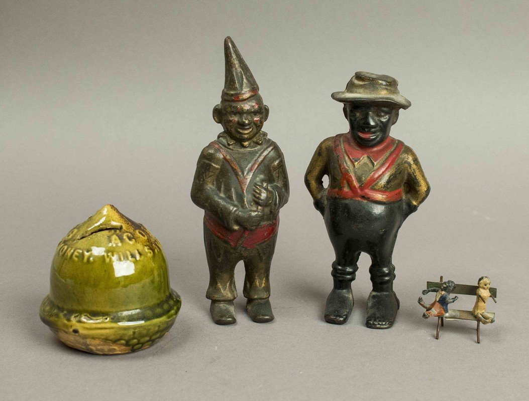 3 Still Banks & a Black Americana Lead Piece: 3 Still Banks & a Black Americana Lead Piece. Two banks are cast iron and one bank, "Acorn Stoves will save half your money," is ceramic. Processing and shipping within the continental U.S. $25.00 plu