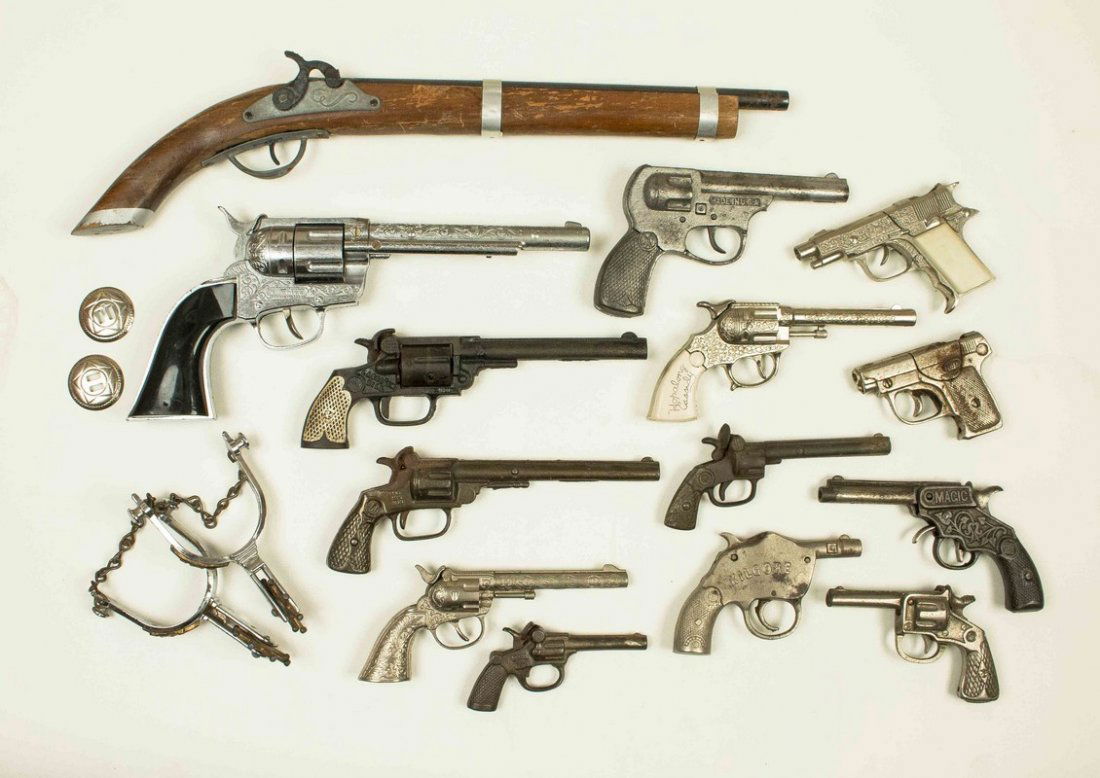 15 Assorted Cap Guns + Spurs: 15 Assorted Cap Guns + Spurs. Guns are in cast iron, wood and pot metal. Cap guns include Kenton "Lasso'em Bill", National "No. 380" and Hubley "Ric-o-shay 5". Processing and shipping within