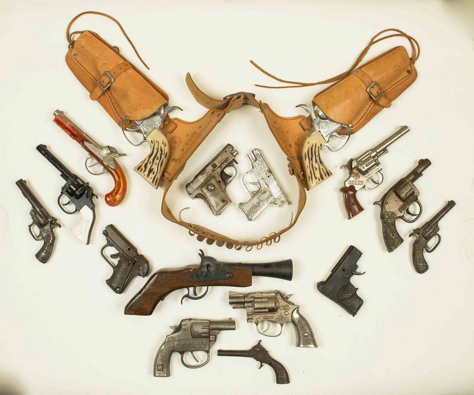 15 Assorted Cap Guns: 15 Assorted Cap Guns, in cast iron, wood and pot metal. Cap guns include Stevens "Navy", "Kilgore Invincible" and Mattel "Fanner 50" two gun holster set. Processing and shipping within the c