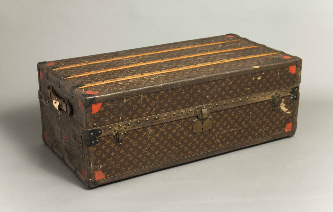 Louis Vuitton Trunk: Louis Vuitton monogram steamer trunk with inner leather compartments and hanging section (leather and brass rivets). Brass hinges marked. Serial number 053099. Red painted quarter circles at exterior