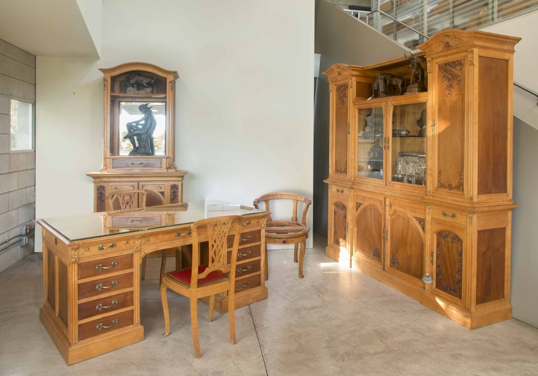 5-Piece Art Nouveau Office Suite: Five piece pearwood/mahogany Art Nouveau office suite comprising a partners desk, bookcase, display case, two reception chairs and an additional round office chair. Accented by sinuous plant form carv