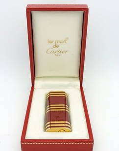 Cartier Red and Gold Lighter. Cartier Issued.  Signed: Cartier Red and Gold Lighter. Cartier Issued. Signed Cartier. Lighter is accompanied with original box.