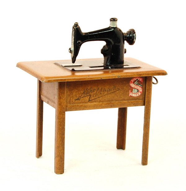 Singer Sewing Machine bank: Tin. 5 1/8 in. tall.