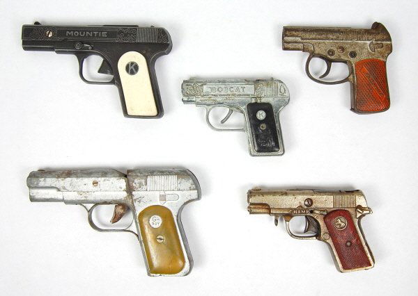 Lot of 5 Cap Guns: "Champ", "Mountie", "National", "Bobcat", & "G-Boy". 5 in., 6 in., 4 1/4 in., 5 in. & 7 1/2 in. respectively.